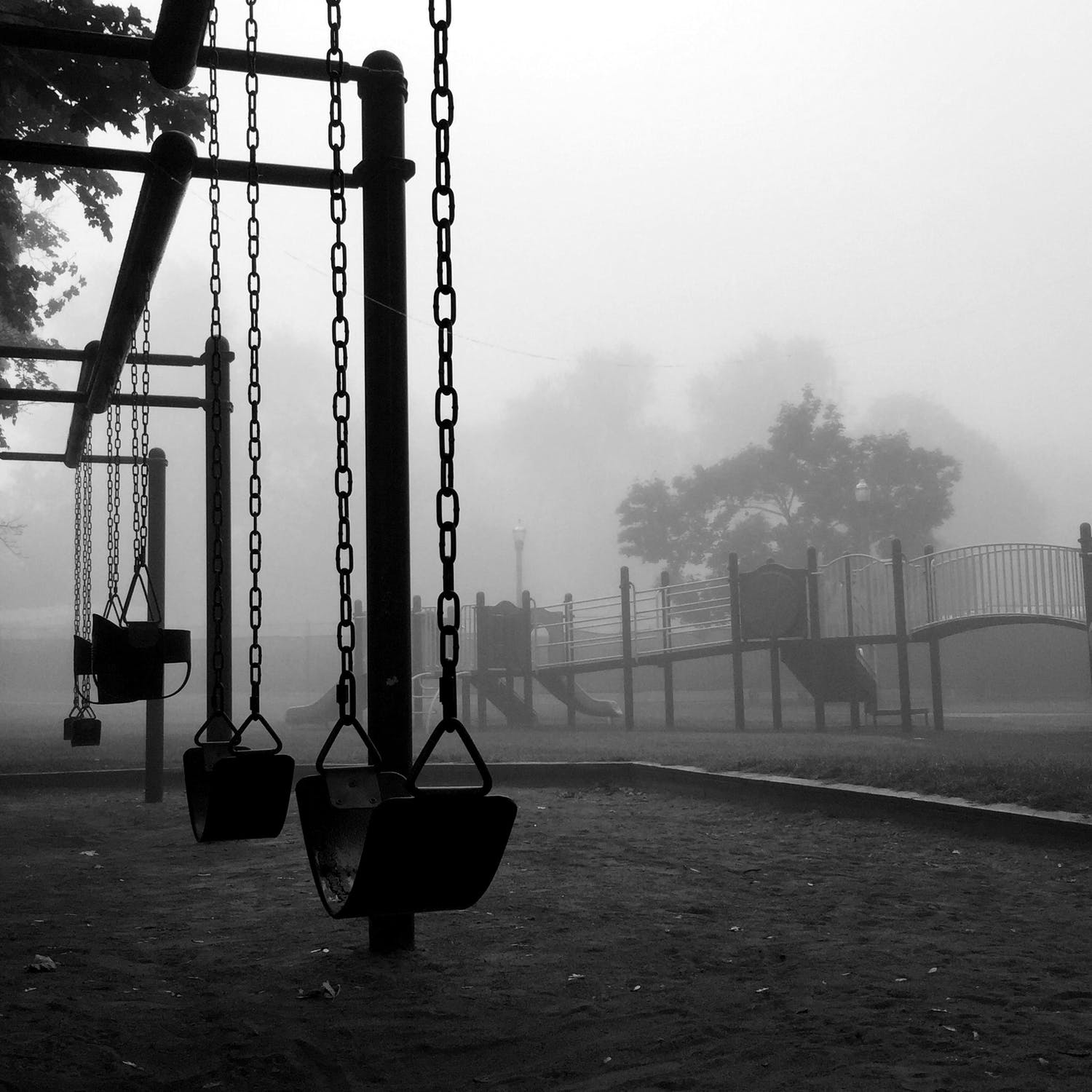 Empty swings on an empty playground